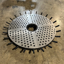 Ember retainer installed on a round fire pit grate